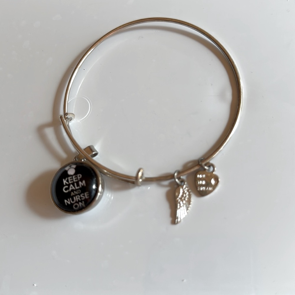 Sterling Silver adjustable wire charm bracelet with 3 Silver tone metal charms.